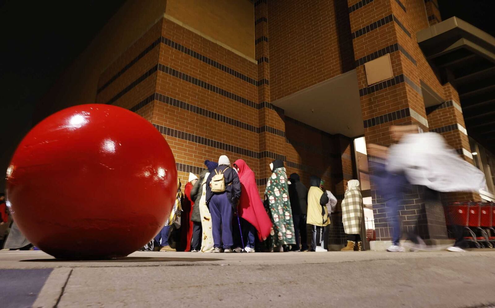 More than 100 early-morning shoppers line up outside Target at Bridgewater Falls in Fairfield Twp. to kick off the holiday shopping season Friday, Nov. 29, 2024. Many people in line were there for special edition Taylor Swift items. NICK GRAHAM/STAFF