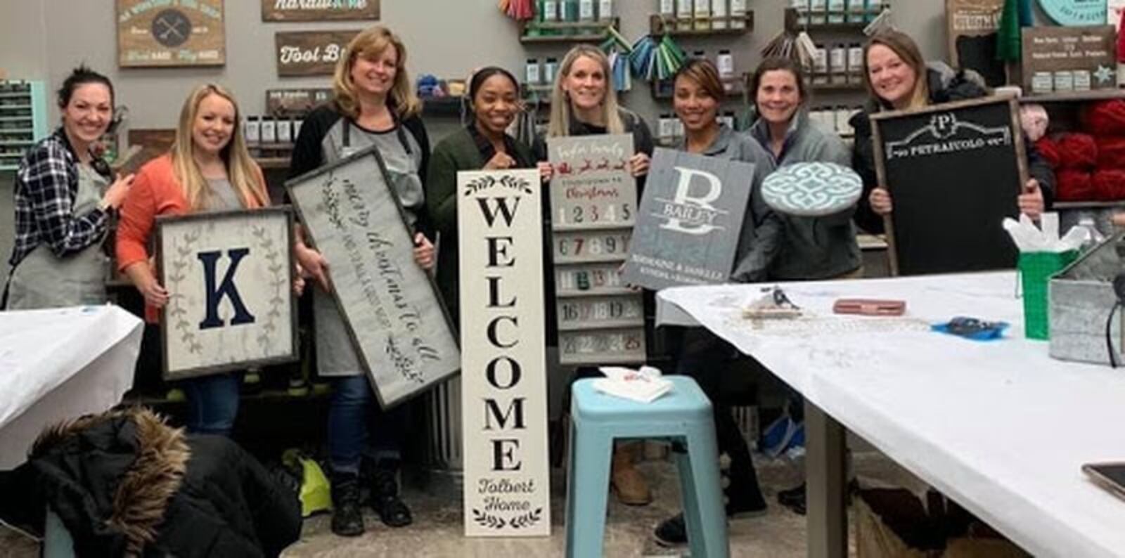 Customers hold up DIY projects that they created at an AR Workshop Centerville event. CONTRIBUTED