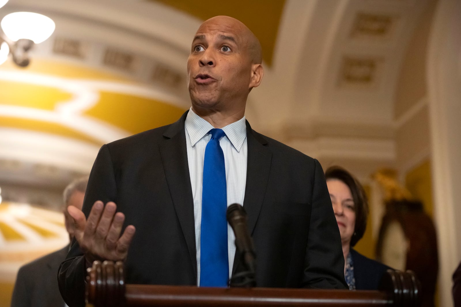 Sen. Cory Booker, D-N.J., speaks to reporters after a Senate policy luncheon on Capitol Hill, Tuesday, March 11, 2025, in Washington. (AP Photo/Mark Schiefelbein)