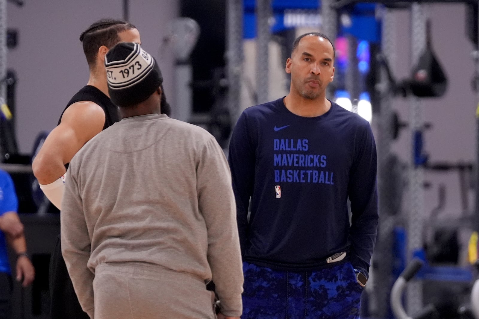 Dallas Mavericks general manager Nico Harrison, right, talks with team staff at the end of an NBA basketball practice at the team's training facility in Dallas, Thursday, Feb. 20, 2025. (AP Photo/Tony Gutierrez)