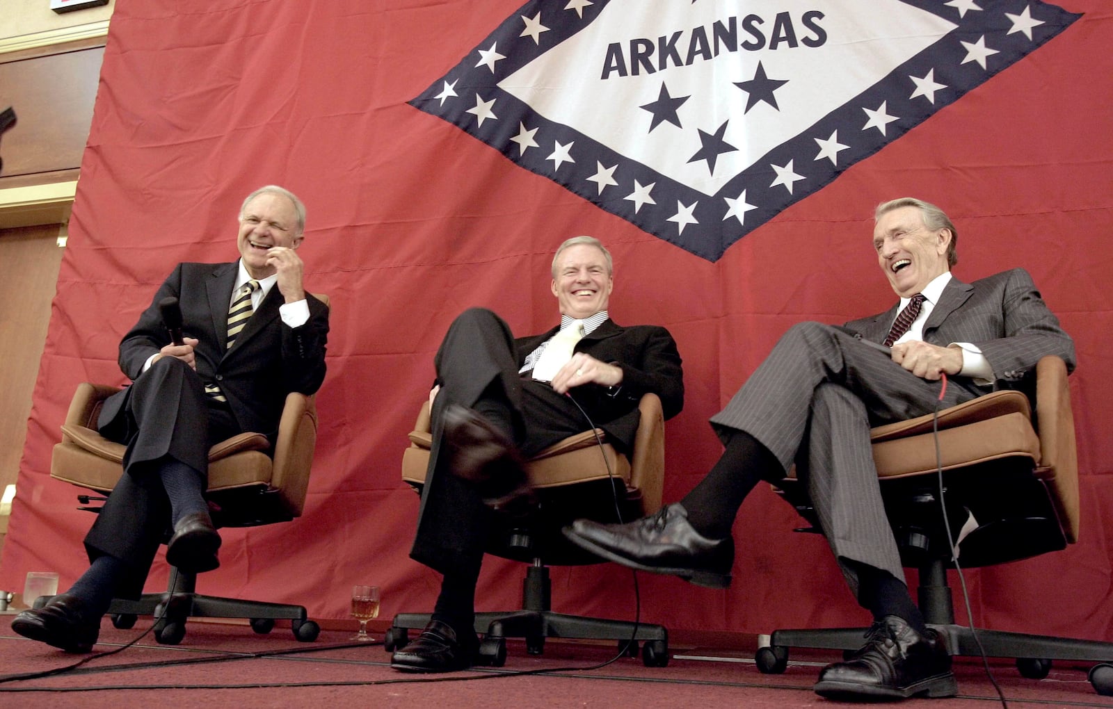 FILE - Former Arkansas Gov. Jim Guy Tucker, center, is joined by former governors and U.S. Sens. David Pryor, left, and Dale Bumpers, right, both D-Ark., at a state party convention in Little Rock, Ark., Aug. 26, 2006. (AP Photo/Danny Johnston, File)