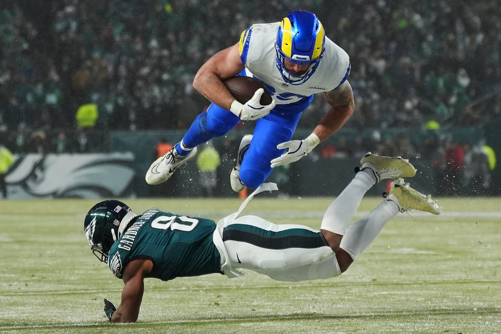 Los Angeles Rams tight end Tyler Higbee (89) is stopped by Philadelphia Eagles safety C.J. Gardner-Johnson (8) during the second half of an NFL football NFC divisional playoff game Sunday, Jan. 19, 2025, in Philadelphia. (AP Photo/Matt Slocum)