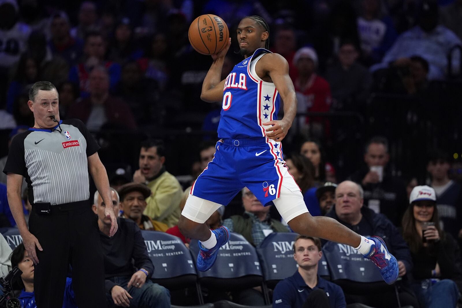 Philadelphia 76ers' Tyrese Maxey saves a ball from going out of bounds during the second half of an NBA basketball game against the Dallas Mavericks, Tuesday, Feb. 4, 2025, in Philadelphia. (AP Photo/Matt Slocum)