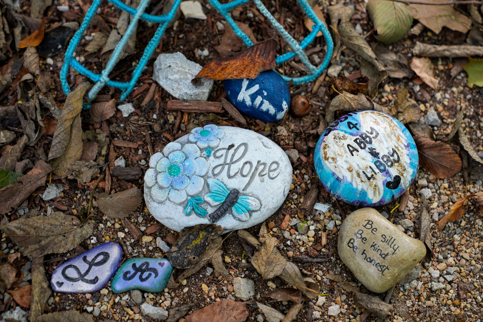 Decorated stones bearing the names of Abigail Williams and Liberty German, who were killed in February 2017, are placed at a memorial along the Monon High Bridge Trail in Delphi, Ind., Tuesday, Oct. 1, 2024. (AP Photo/Michael Conroy)