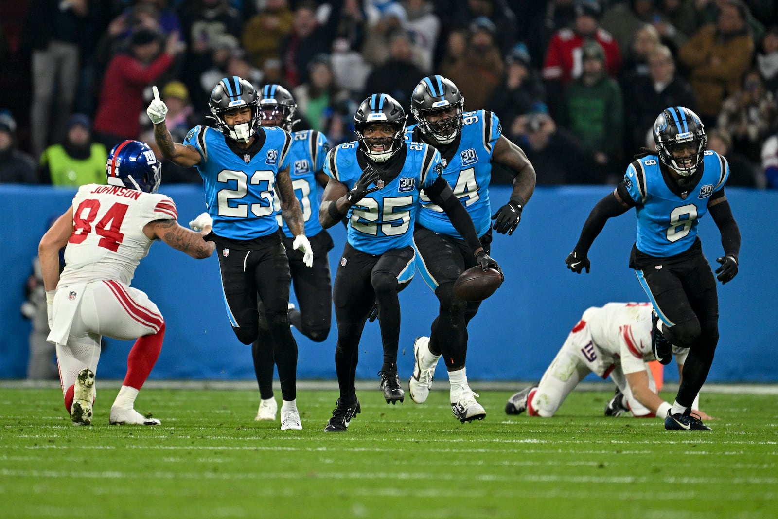 Carolina Panthers safety Xavier Woods intercepts a pass against the New York Giants during the first half of an NFL football game, Sunday, Nov. 10, 2024, in Munich, Germany. (AP Photo/Lennart Preiss)