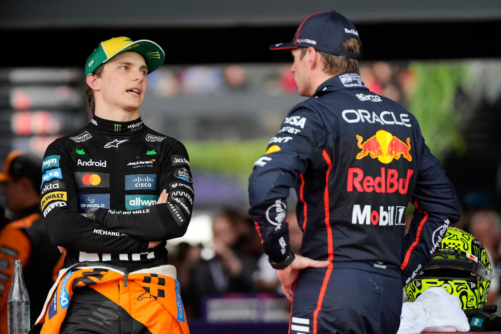 McLaren driver Oscar Piastri, left, of Australia and Red Bull driver Max Verstappen of the Netherlands talk following qualifying at the Australian Formula One Grand Prix at Albert Park, in Melbourne, Australia, Saturday, March 15, 2025. (AP Photo/Asanka Brendon Ratnayake)