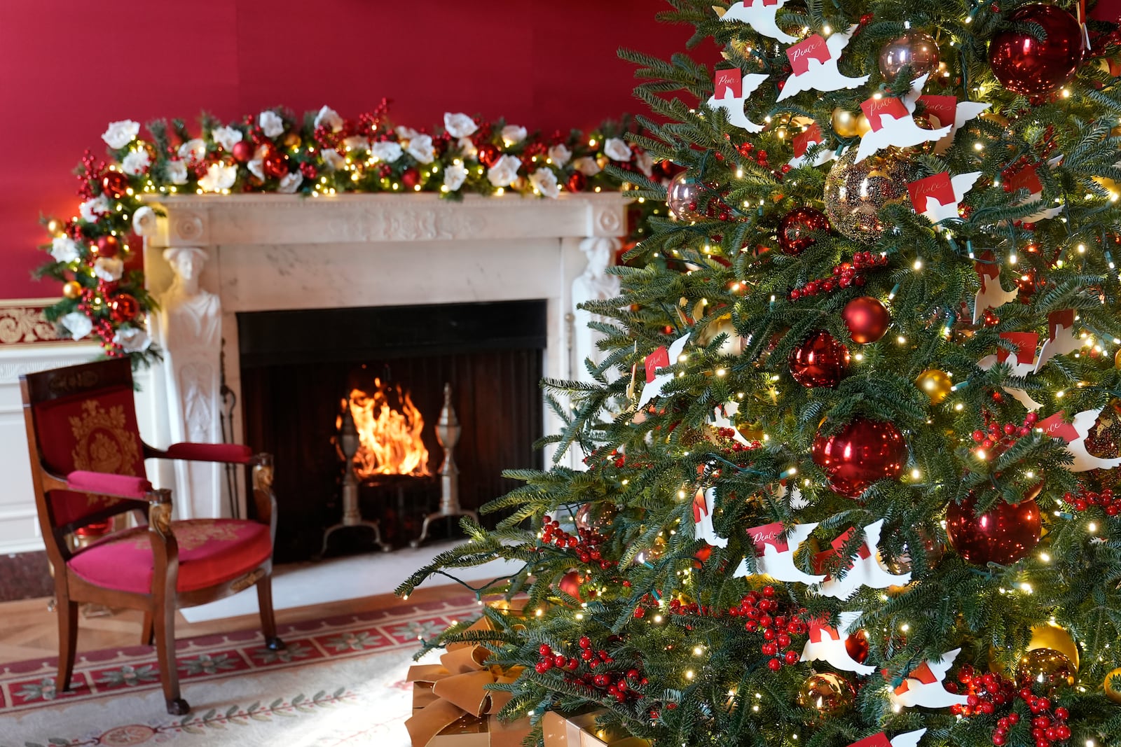 The Red Room of the White House in Washington, is decorated for the holidays, Monday, Dec. 2, 2024. (AP Photo/Susan Walsh)