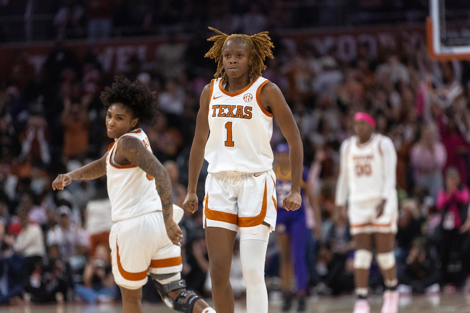 Texas guard Bryanna Preston (1) celebrates scoring against LSU with guard Rori Harmon (3) during the second half of an NCAA college basketball game in Austin, Texas, Sunday, Feb. 16, 2025. (AP Photo/Stephen Spillman)