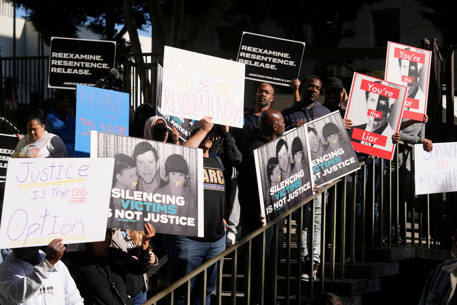 Supporters hold signs during a press conference regarding developments in the Menendez brothers case Thursday, March 20, 2025, in Los Angeles. (AP Photo/Damian Dovarganes)