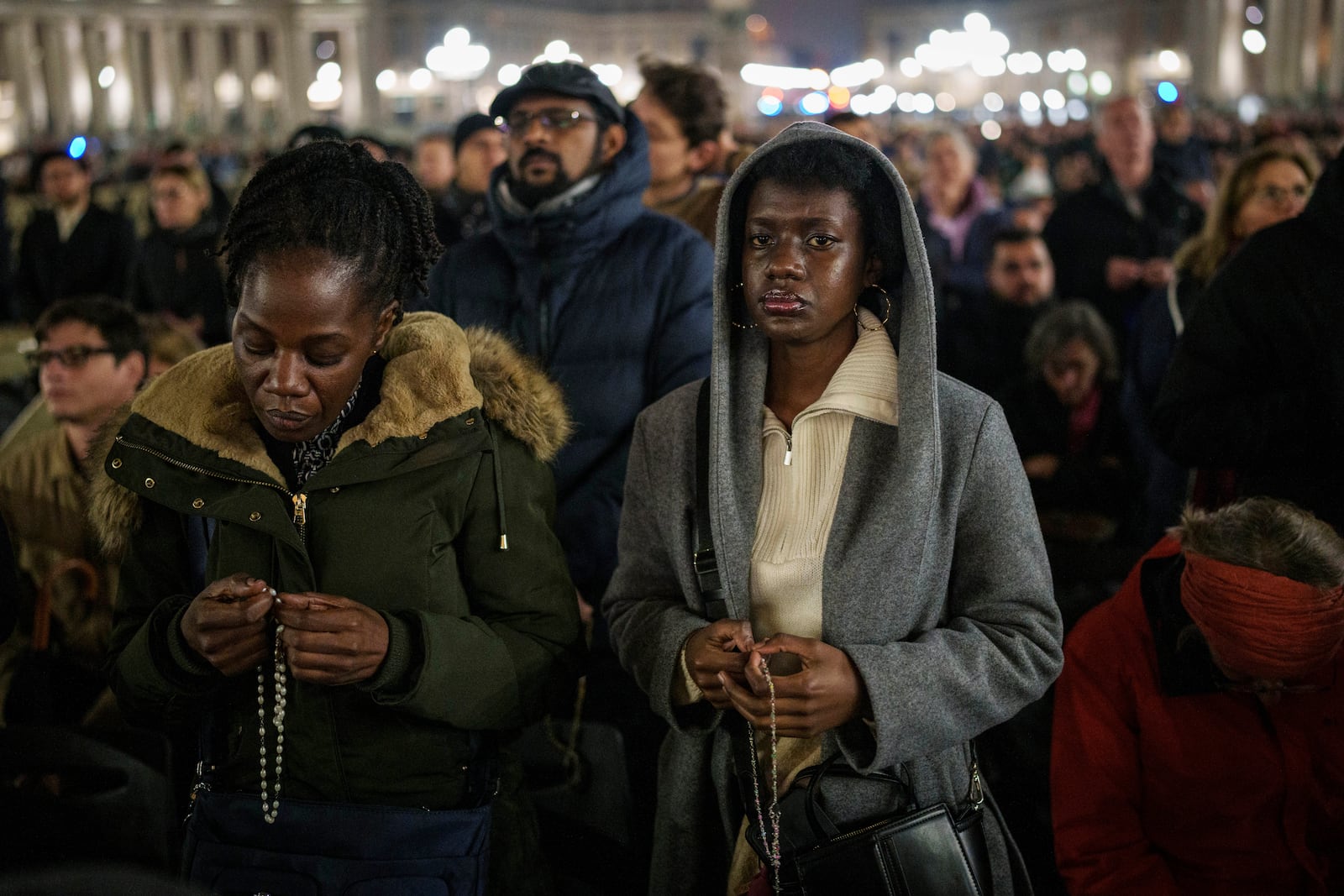 Catholic worshippers gather during a prayer of the Rosary for Pope Francis in St. Peter's Square at The Vatican, Monday, Feb. 24, 2025. (AP Photo/Bernat Armangue)