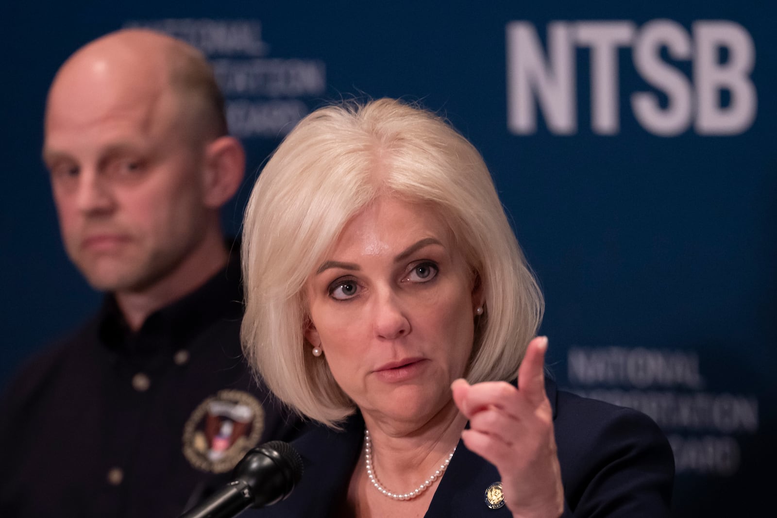 National Transportation Safety Board (NTSB) Chairwoman Jennifer Homendy, accompanied by investigator in charge Brice Banning, left, speaks about the recent mid-air collision of an American Airlines flight and a Black Hawk helicopter near Ronald Reagan Washington National Airport, at a news conference in Washington, Tuesday, March 11, 2025. (AP Photo/Ben Curtis)