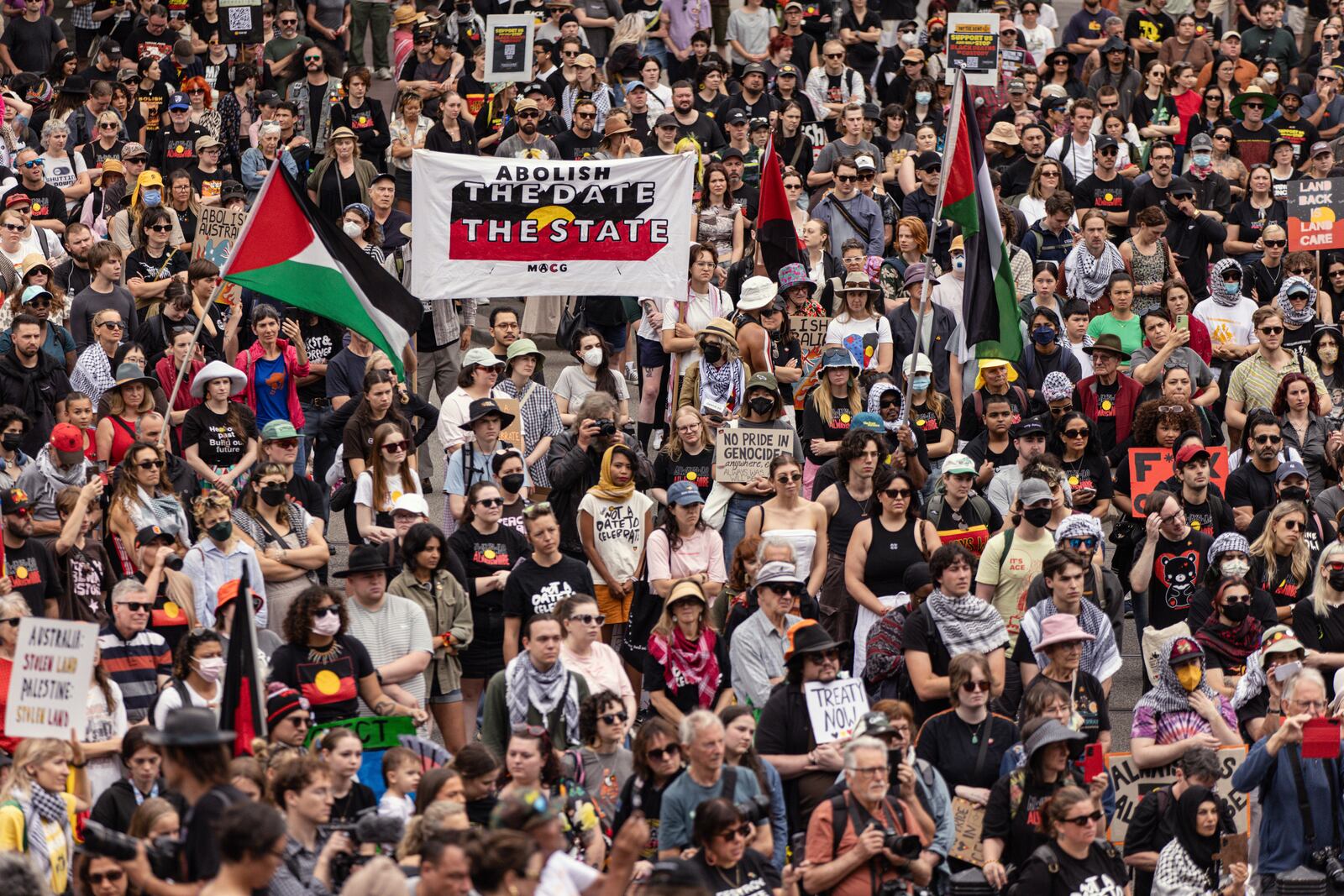 People gather in front of the Victorian state parliament during an Invasion Day rally on Australia Day in Melbourne, Sunday, Jan. 26, 2025. (Diego Fedele/AAP Image via AP)