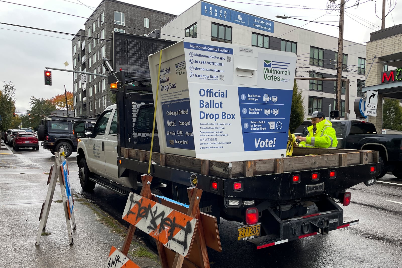 A replacement ballot drop box is unloaded on Monday, Oct. 28, 2024, in Portland, Ore. (AP Photo/Claire Rush)