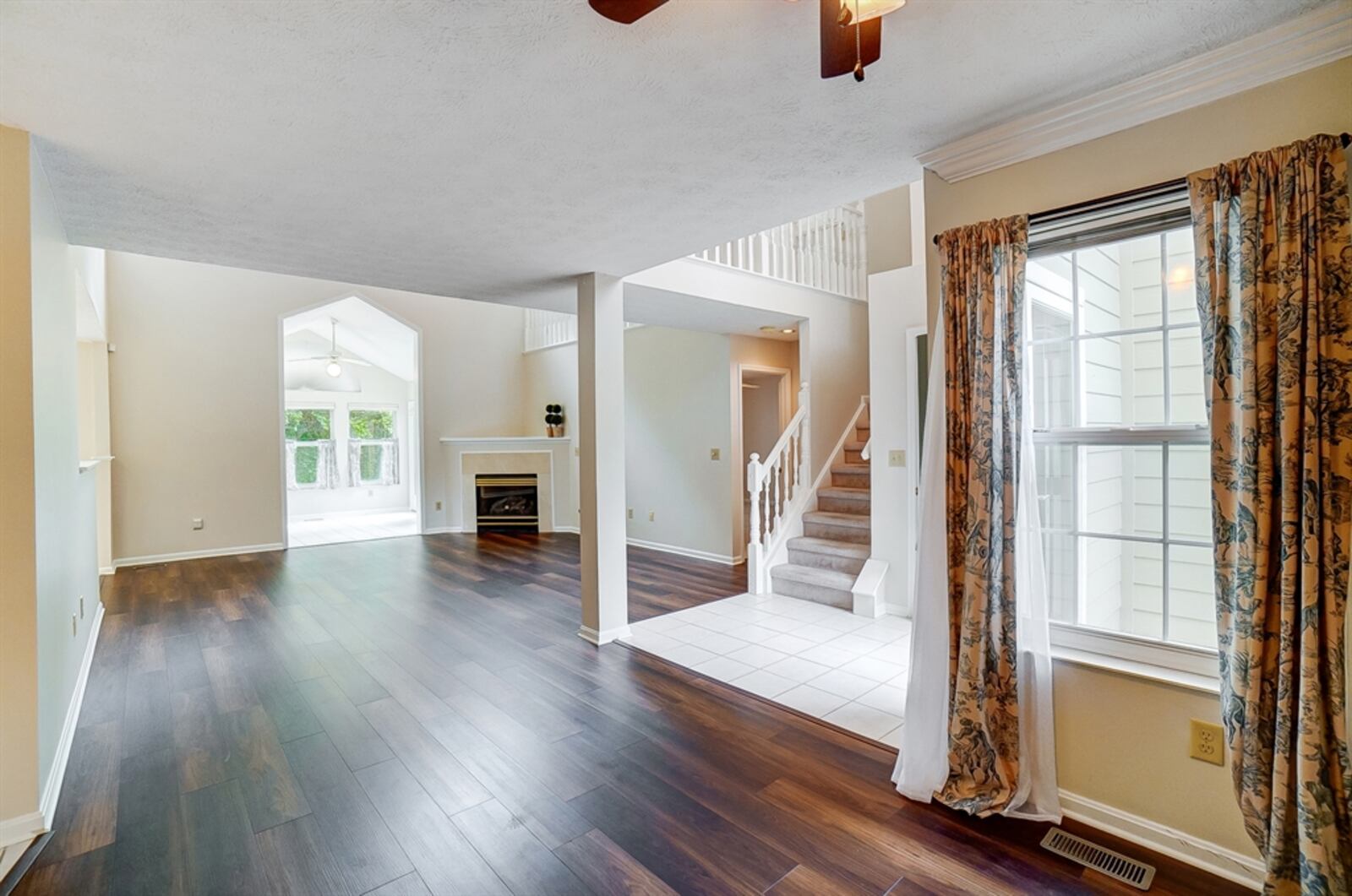 Wood spindles accent the railing that starts with the semi-open staircase and around the upstairs family room loft, catwalk hallway and loft sitting area. 