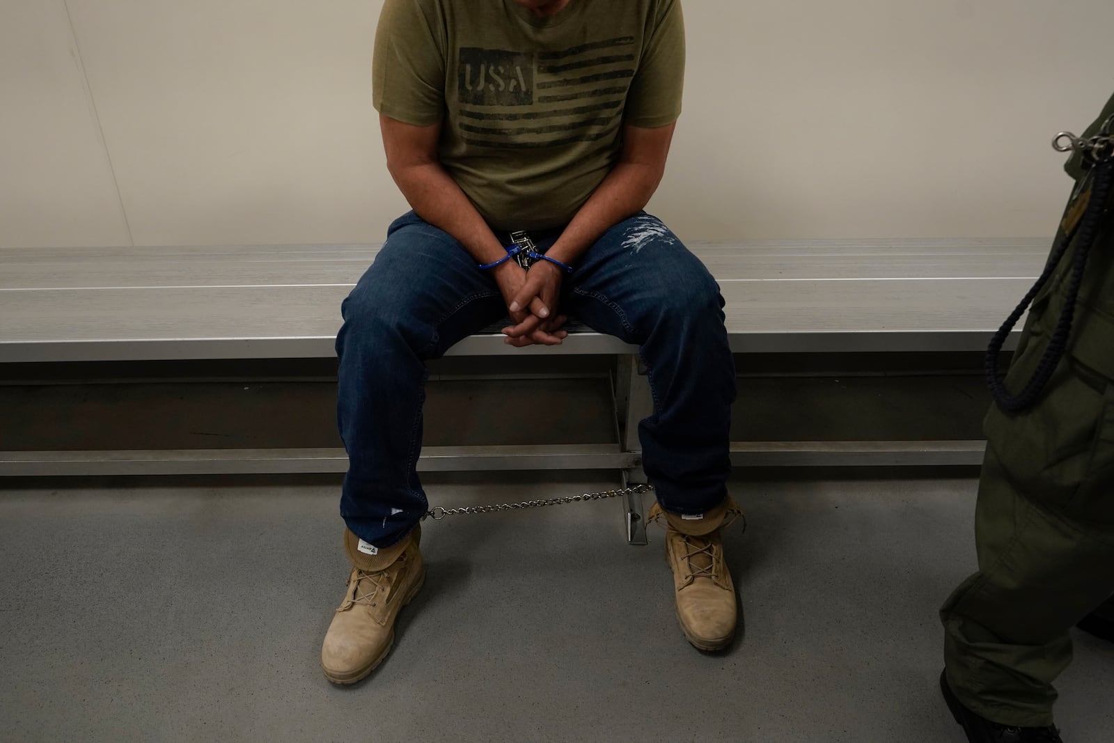 FILE - An immigrant considered a threat to public safety and national security waits to be processed by U.S. Immigration and Customs Enforcement agents at the ICE Metropolitan Detention Center in Los Angeles, after an early morning raid, June 6, 2022. (AP Photo/Damian Dovarganes, File)