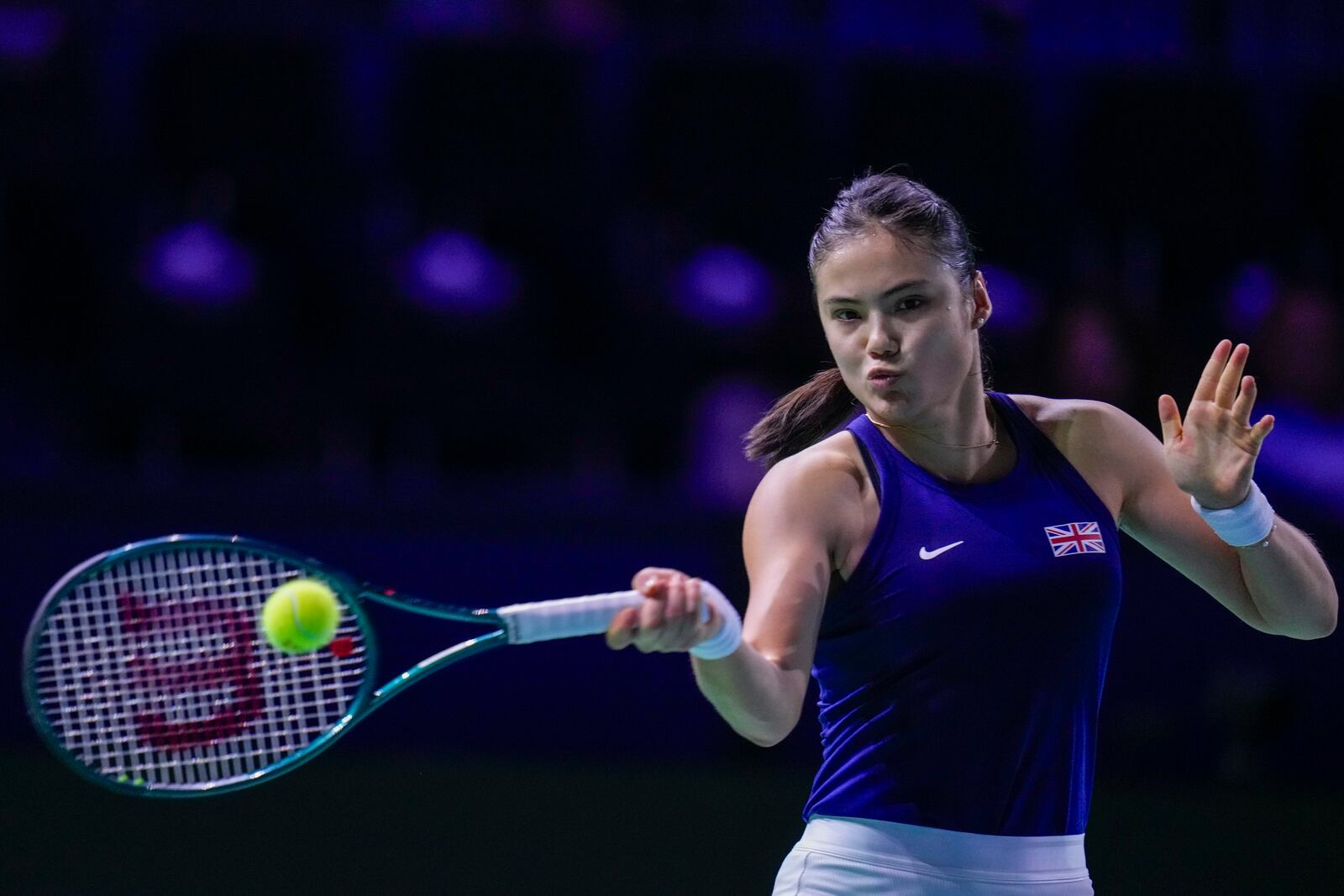 Emma Raducanu of Britain returns the ball to Germany's Jule Niemeier during the Billie Jean King Cup Finals, at the Martin Carpena Sports Hall, in Malaga, southern Spain, on Friday, Nov. 15, 2024. (AP Photo/Manu Fernandez)