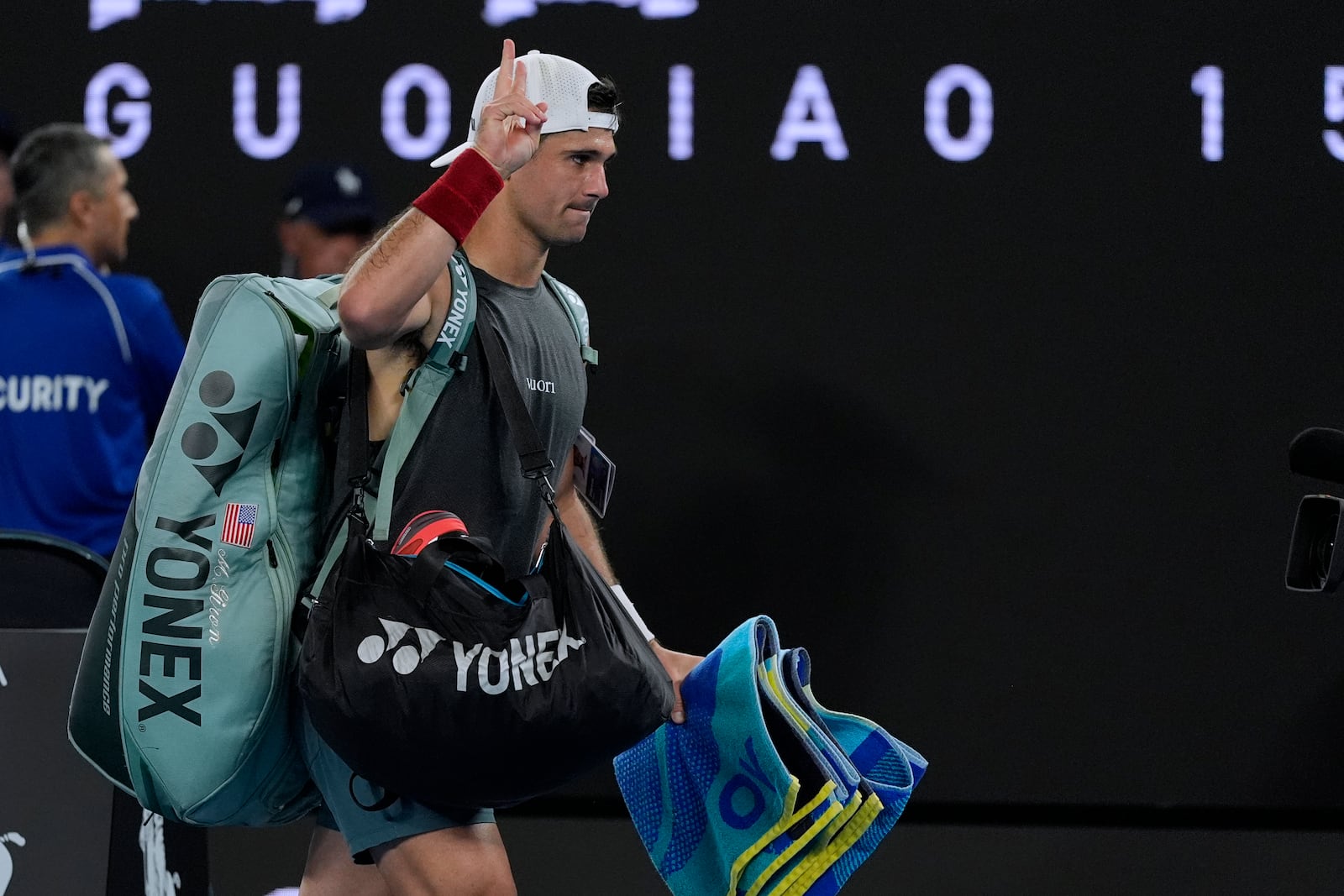 Marcos Giron of the U.S. gestures as he walks from Rod Laver Arena following his third round loss to Jannik Sinner of Italy at the Australian Open tennis championship in Melbourne, Australia, Saturday, Jan. 18, 2025. (AP Photo/Asanka Brendon Ratnayake)