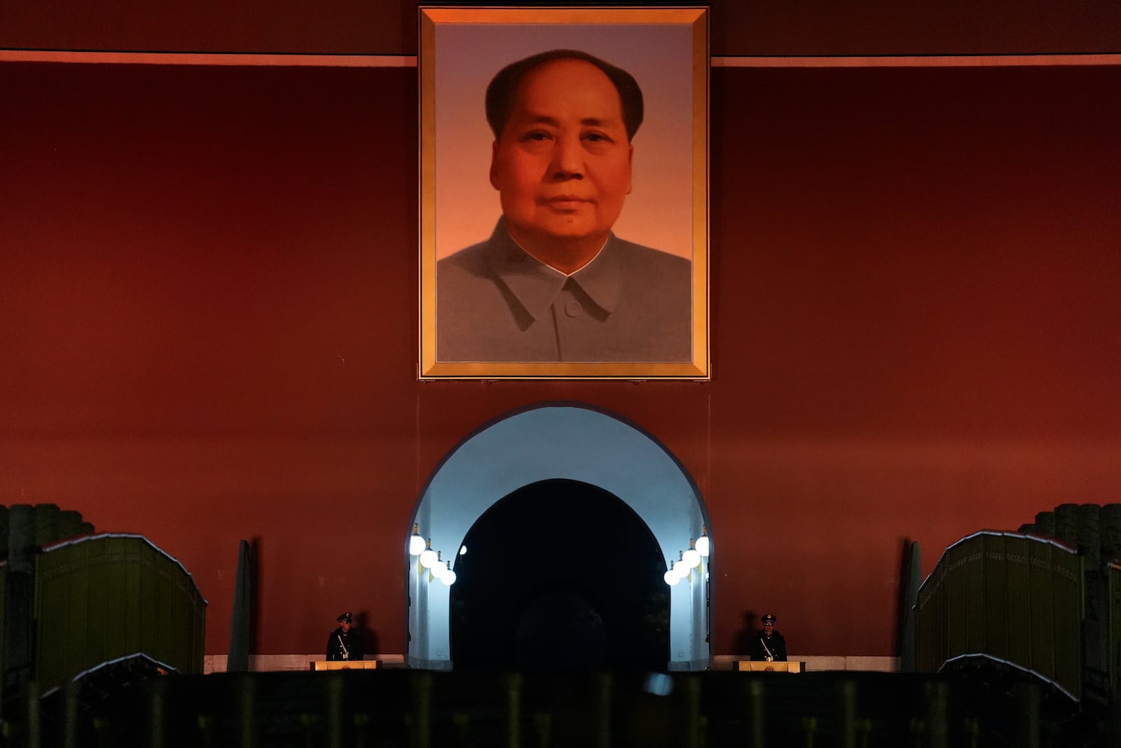 Chinese paramilitary policemen stand guard below a giant portrait of late Chinese leader Mao Zedong hung on Tiananmen Gate in Beijing, China, Wednesday, July 5, 2025. (AP Photo/Ng Han Guan)