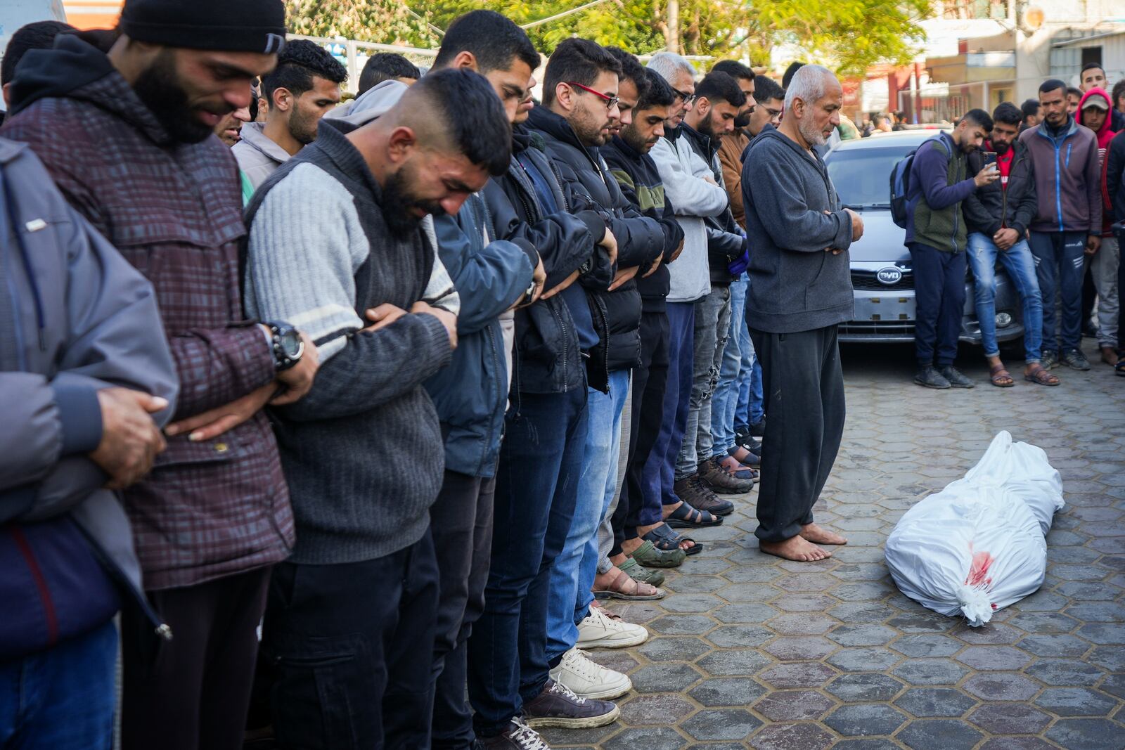 Palestinians pray over the body before the funeral of a man killed during an Israeli army strike in Deir al-Balah in the central Gaza Strip, Thursday Jan. 2, 2025.(AP Photo/Abdel Kareem Hana)