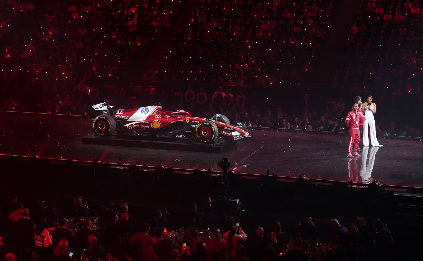 Ferrari driver Lewis Hamilton, front right, looks up during the F1 75 Live event at the O2 arena in London, England, Tuesday, Feb. 18, 2025. (Bradley Collyer/PA via AP)