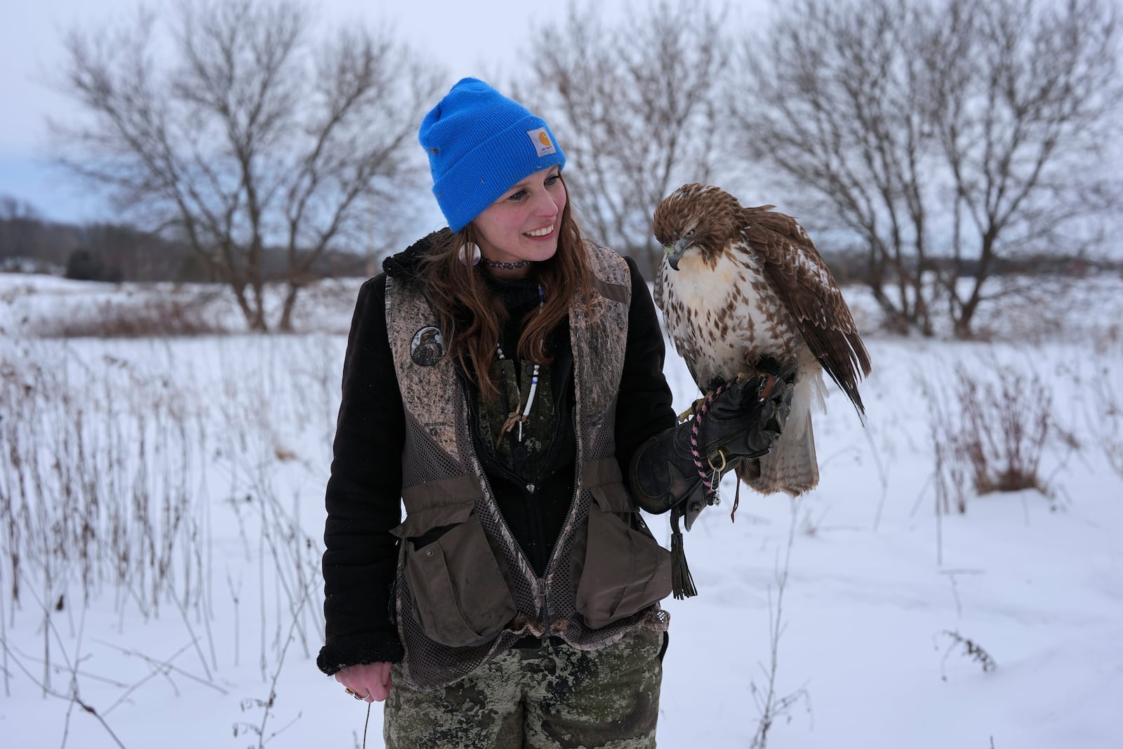 Stephanie Stevens poses for a portrait with her hunting hawk Alexie Echo-Hawk on Friday, Feb. 14, 2025, in Greenleaf, Wis. (AP Photo/Joshua A. Bickel)