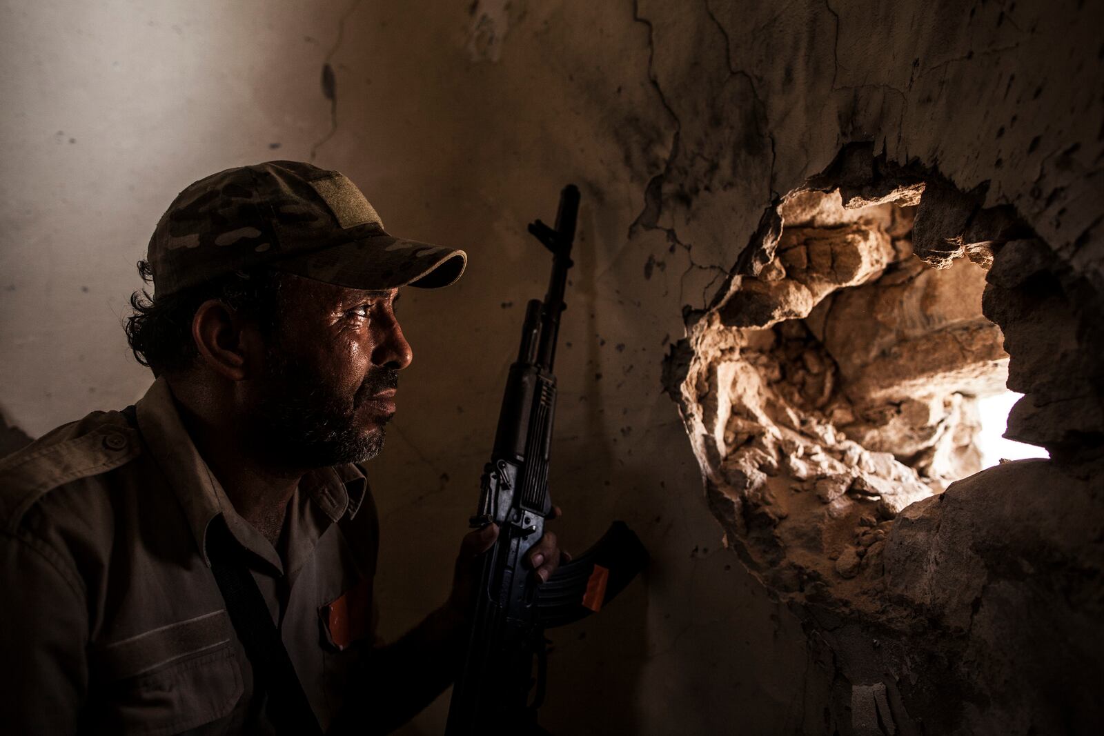 FILE - In this Sept. 22, 2016, file photo, a fighter of the Libyan forces affiliated to the Tripoli government scans for targets from the minaret of a mosque in Sirte, Libya. The warring parties in Libya and their international backers — the United Arab Emirates, Russia and Jordan vs Turkey and Qatar — violated a U.N. arms embargo on the oil-rich north African country that remains “totally ineffective,” U.N. experts said in a new report. (AP Photo/Manu Brabo, File)