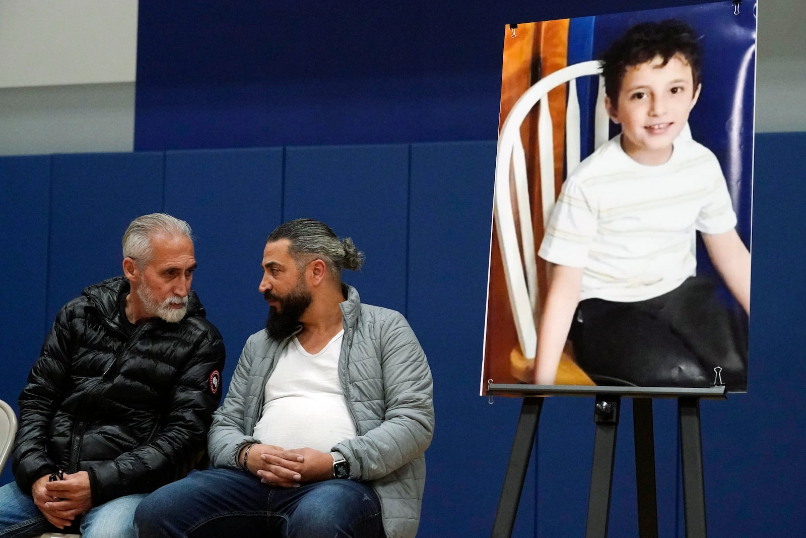 FILE - Wadee Alfayoumi's father, Oday Al Fayoume, seated right, and his uncle Mahmoud Yousef attend a vigil for Wadee at Prairie Activity and Recreation center in Plainfield, Ill., Oct. 17, 2023. (AP Photo/Nam Y. Huh, File)