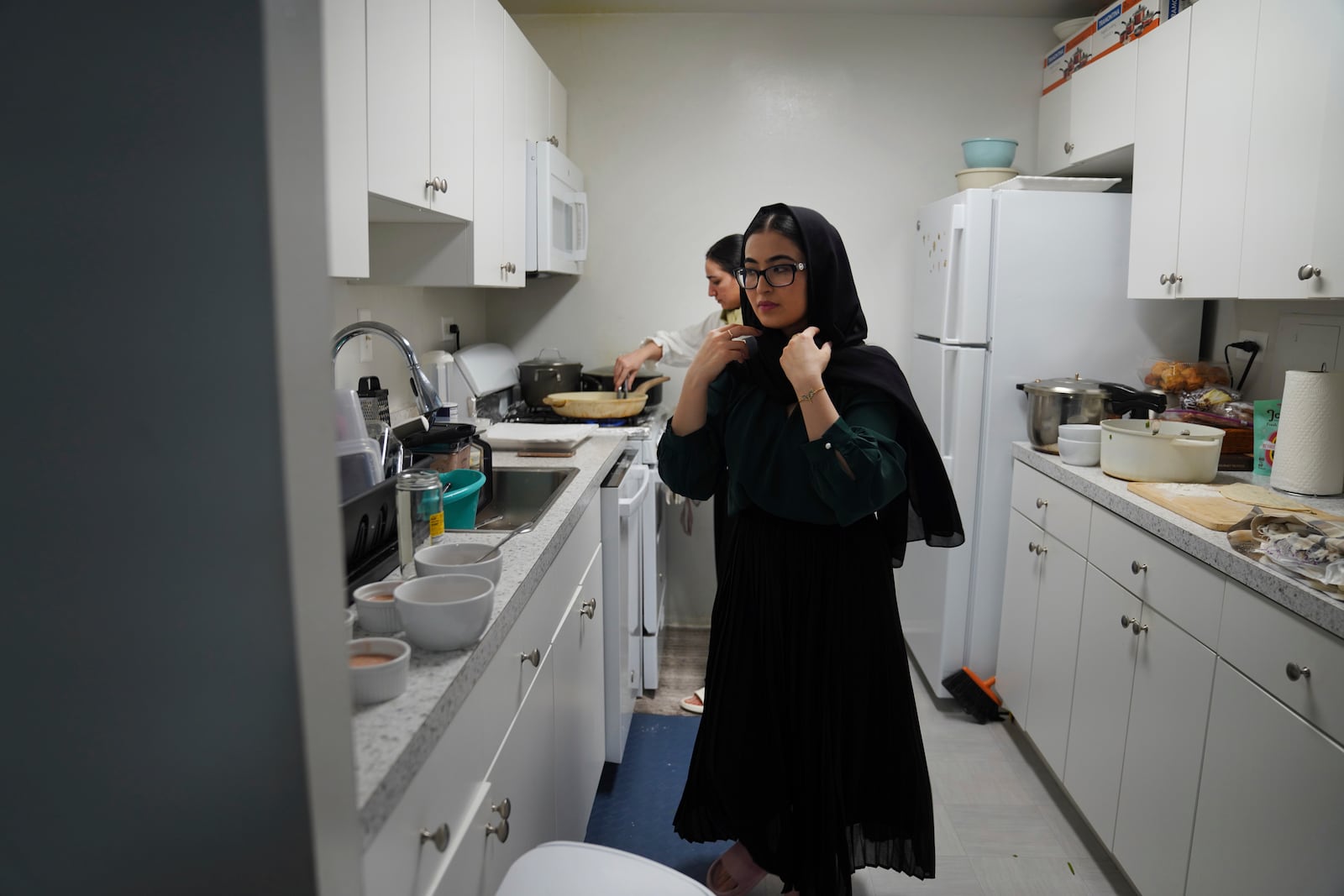 Marjila Badakhsh and her roommates cook together before breaking their fast during the Muslim holy month of Ramadan at their apartment in Alexandria, Va., Wednesday, March 5, 2025. (AP Photo/Jessie Wardarski)