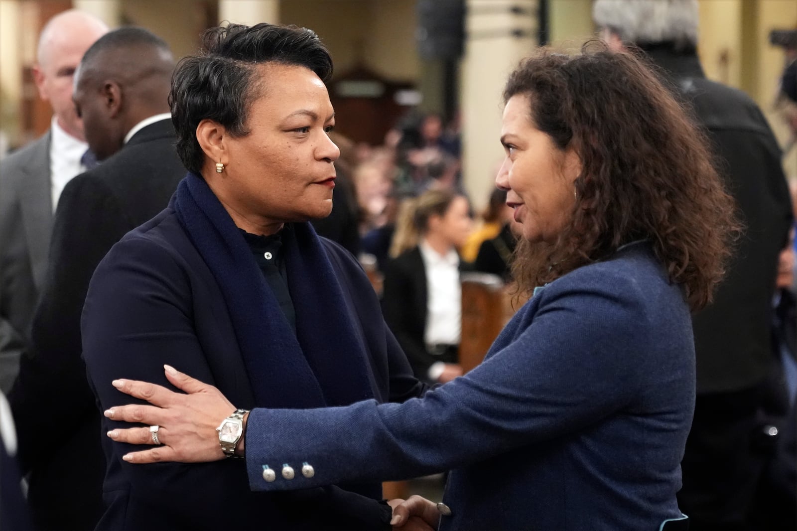 New Orleans Mayor LaToya Cantrell, left, greets city council member Lesli Harris before an interfaith prayer service for the victims of the deadly New Years truck attack, at St. Louis Cathedral in New Orleans, Monday, Jan. 6, 2025. (AP Photo/Gerald Herbert)