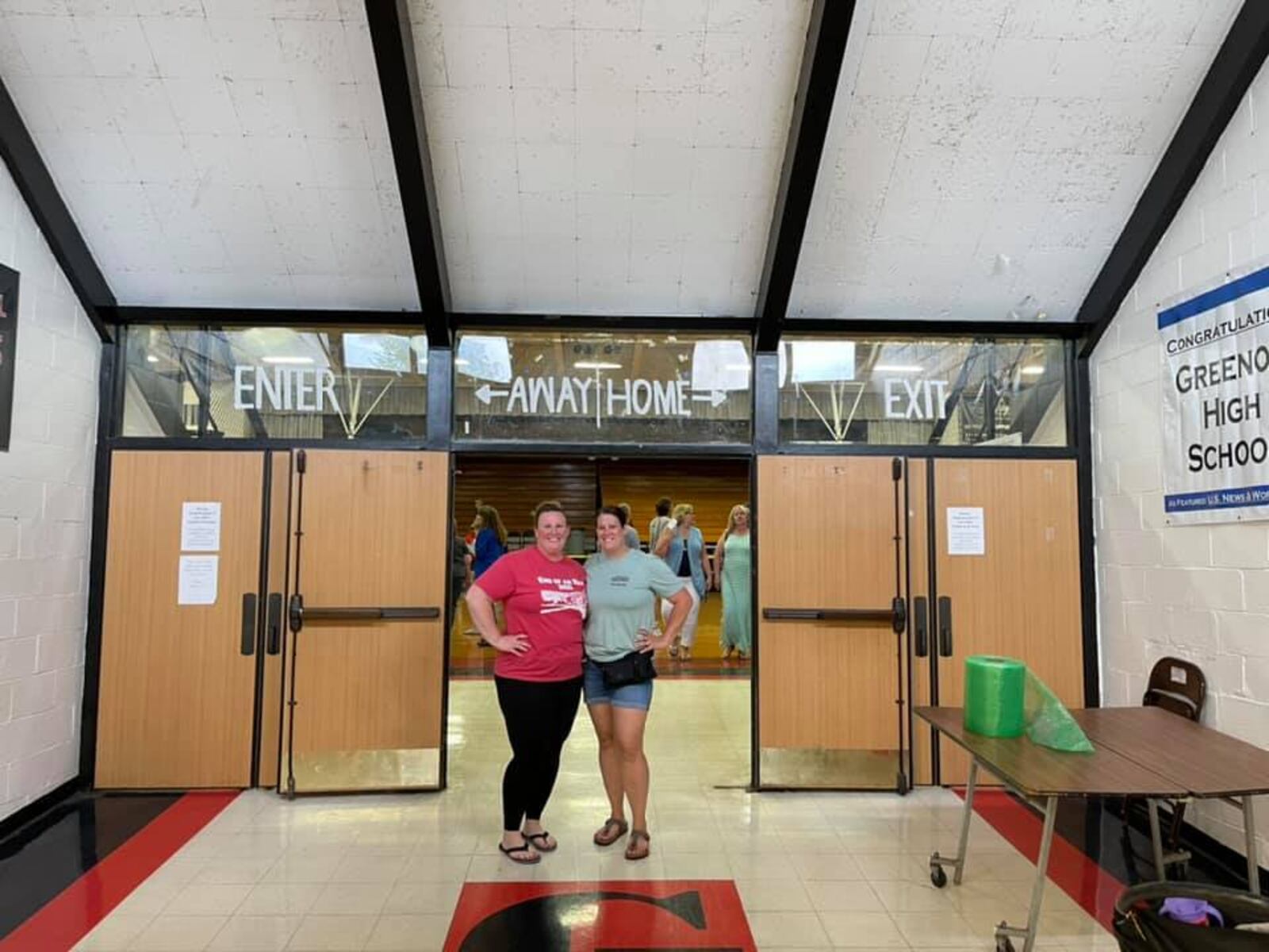 The Crabtree sisters, Stacie McConehea and Sarah Suarez at the Greenon High School gym entrance. Submitted photo