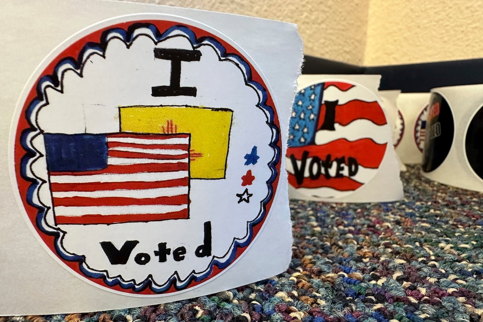 Rolls of I Voted stickers that were designed by students as part of a contest are ready to be given out to voters at an early voting center in Albuquerque, N.M., on Wednesday, Oct. 30, 2024. (AP Photo/Susan Montoya Bryan)