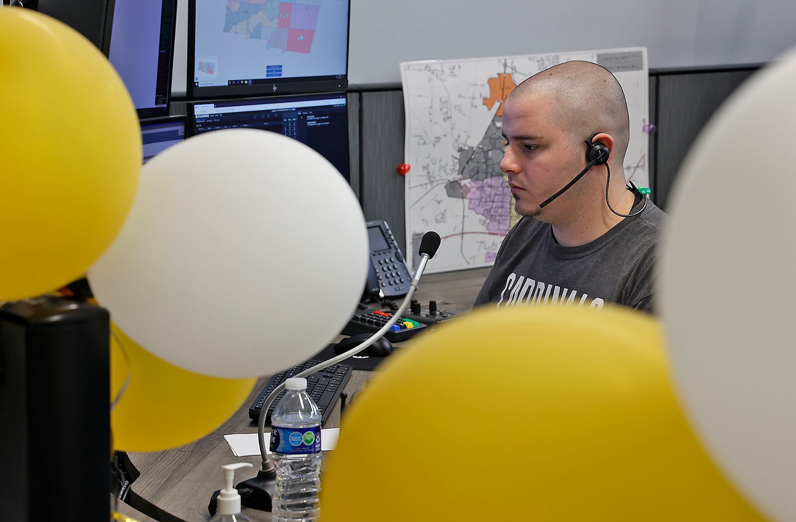 Clark County dispatcher Tyler Franklin is seen through balloons that were placed around the new combined Clark County Dispatch Center to celebrate its opening Tuesday, Feb. 28, 2023. BILL LACKEY/STAFF