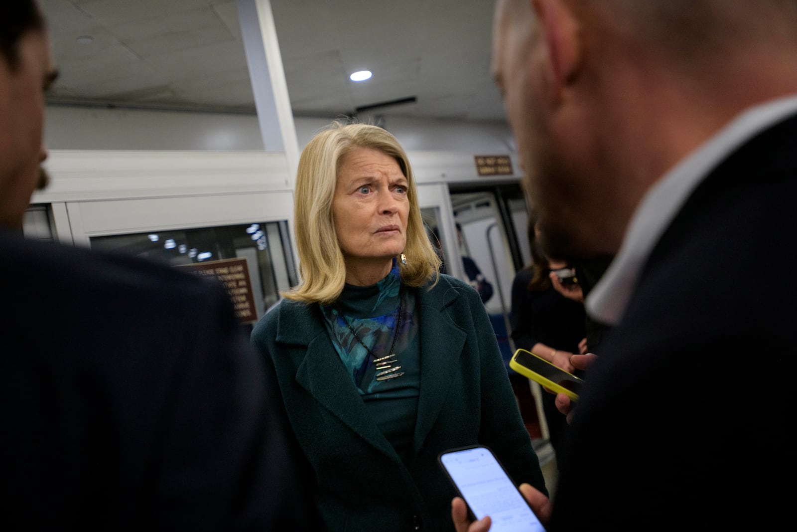 Sen. Lisa Murkowski, R-Alaska, talks with reporters as she makes her way through the Senate subway, Thursday, Jan. 23, 2025, in Washington. (AP Photo/Rod Lamkey, Jr.)