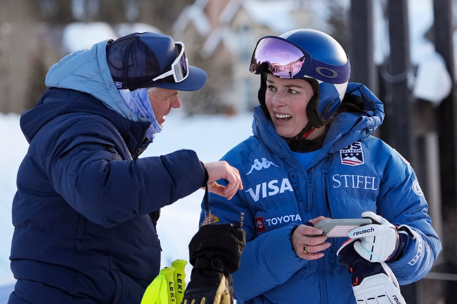 Lindsey Vonn talks with a coach after competing in a Super G skiing race at Copper Mountain Ski Resort, Sunday, Dec. 8, 2024, in Copper Mountain, Colo. (AP Photo/Robert F. Bukaty)