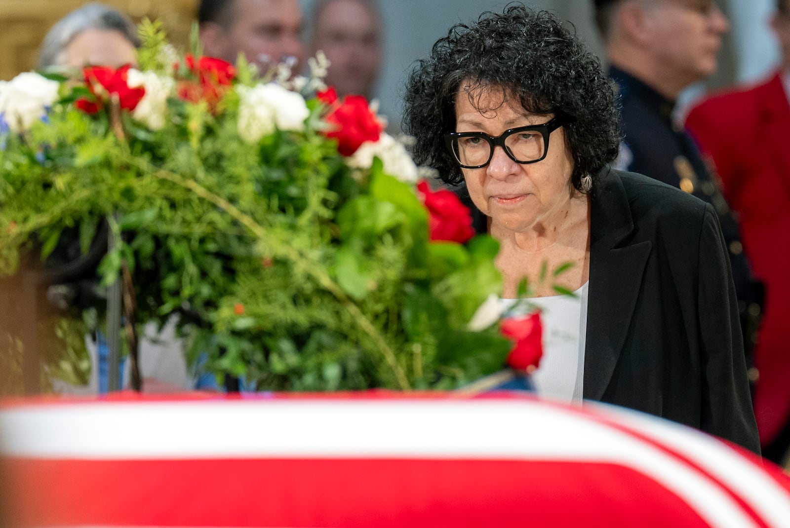 Supreme Court Associate Justice Sonia Sotomayor pays her respects at the side of the flag-draped casket of former President Jimmy Carter as he lies in state in the Capitol, Wednesday, Jan. 8, 2025, in Washington. (AP Photo/Jacquelyn Martin)