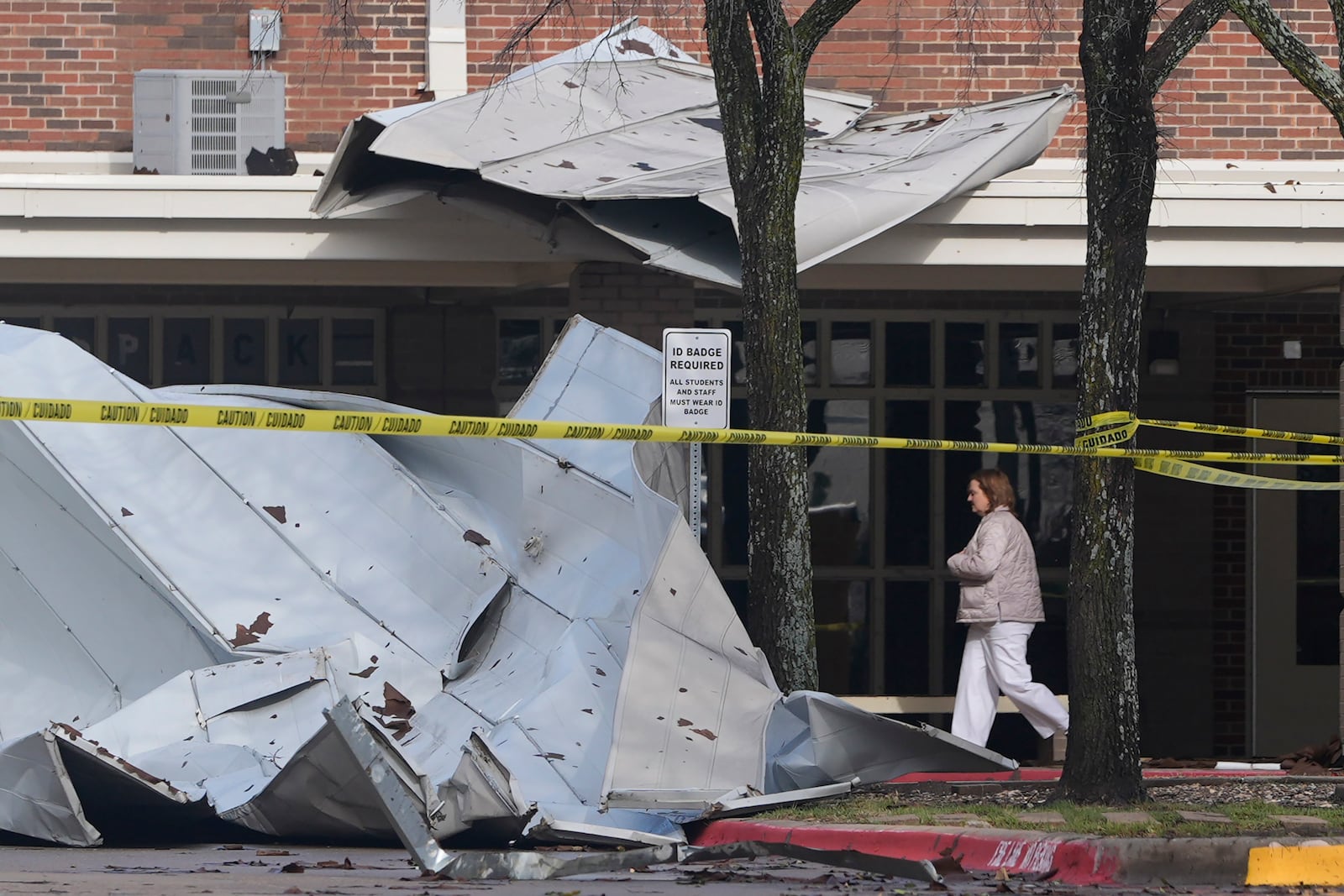 Damage from the roof that was sheered off by high by winds sits in front of Plano West High School Tuesday, March 4, 2025, in Plano, Texas. (AP Photo/LM Otero)