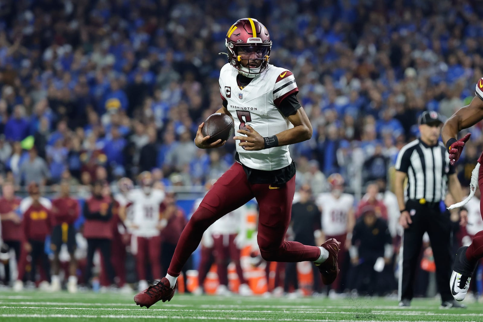 Washington Commanders quarterback Jayden Daniels (5) looks to run the ball against the Detroit Lions during the first half of an NFL football divisional playoff game, Saturday, Jan. 18, 2025, in Detroit. (AP Photo/Rey Del Rio)