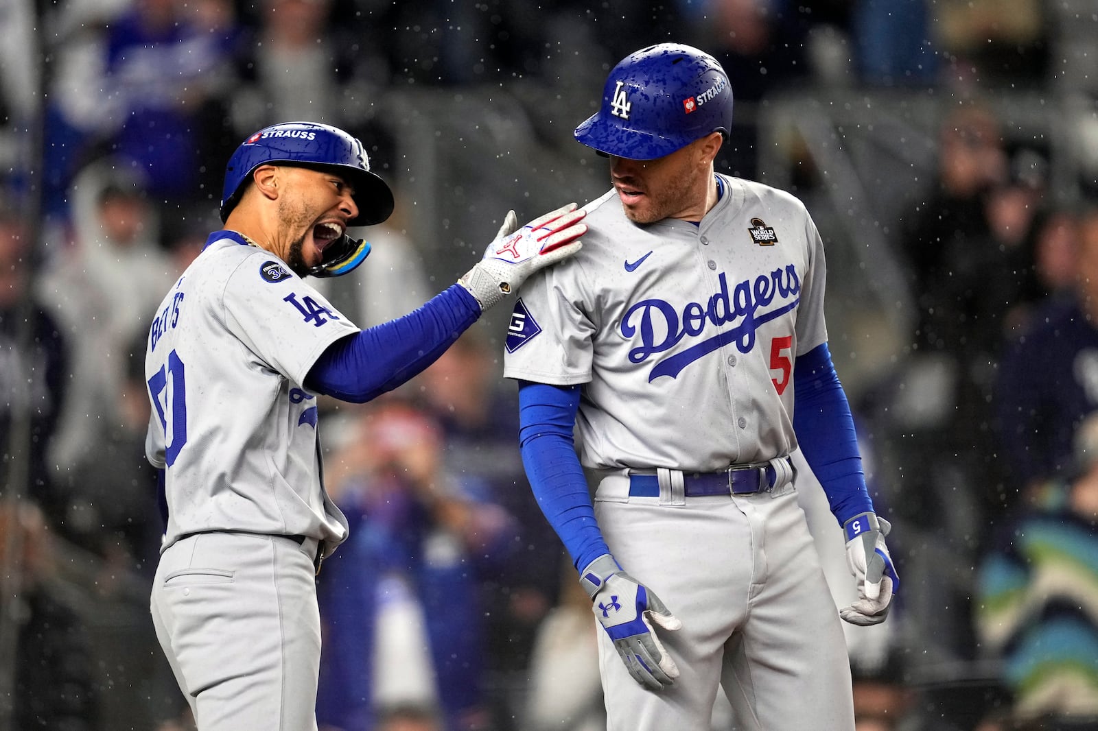 Los Angeles Dodgers' Freddie Freeman (5) and Mookie Betts celebrate after both scored on Freman's two-run home run against the New York Yankees during the first inning in Game 4 of the baseball World Series, Tuesday, Oct. 29, 2024, in New York. (AP Photo/Godofredo A. Vásquez)