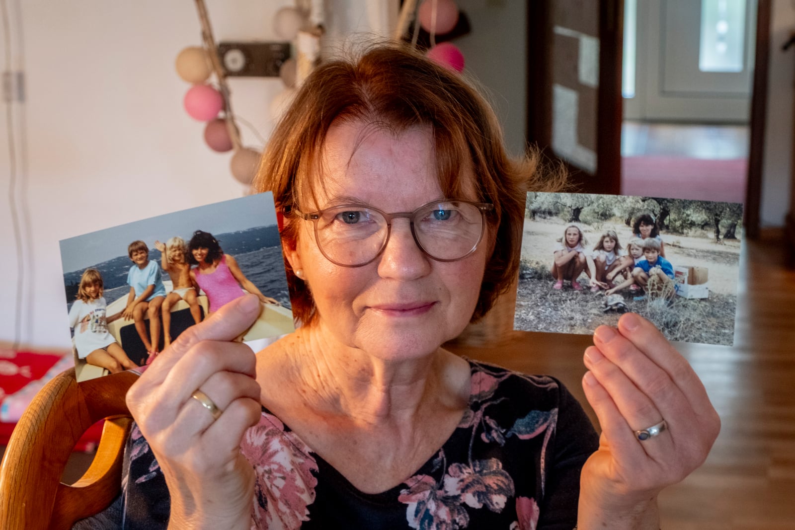 Claudia Huth shows old photos of her children and herself in her house in Egelsbach, Germany, Thursday, Oct. 31, 2024. (AP Photo/Michael Probst)