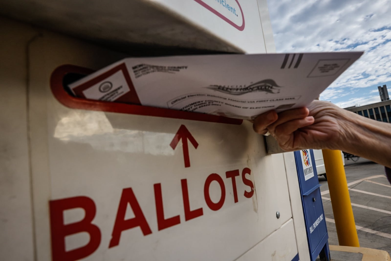 File - A Montgomery County voter drops her ballot off in the dropbox outside the Montgomery County Board of Election in November 2023. Jim Noelker/Staff 