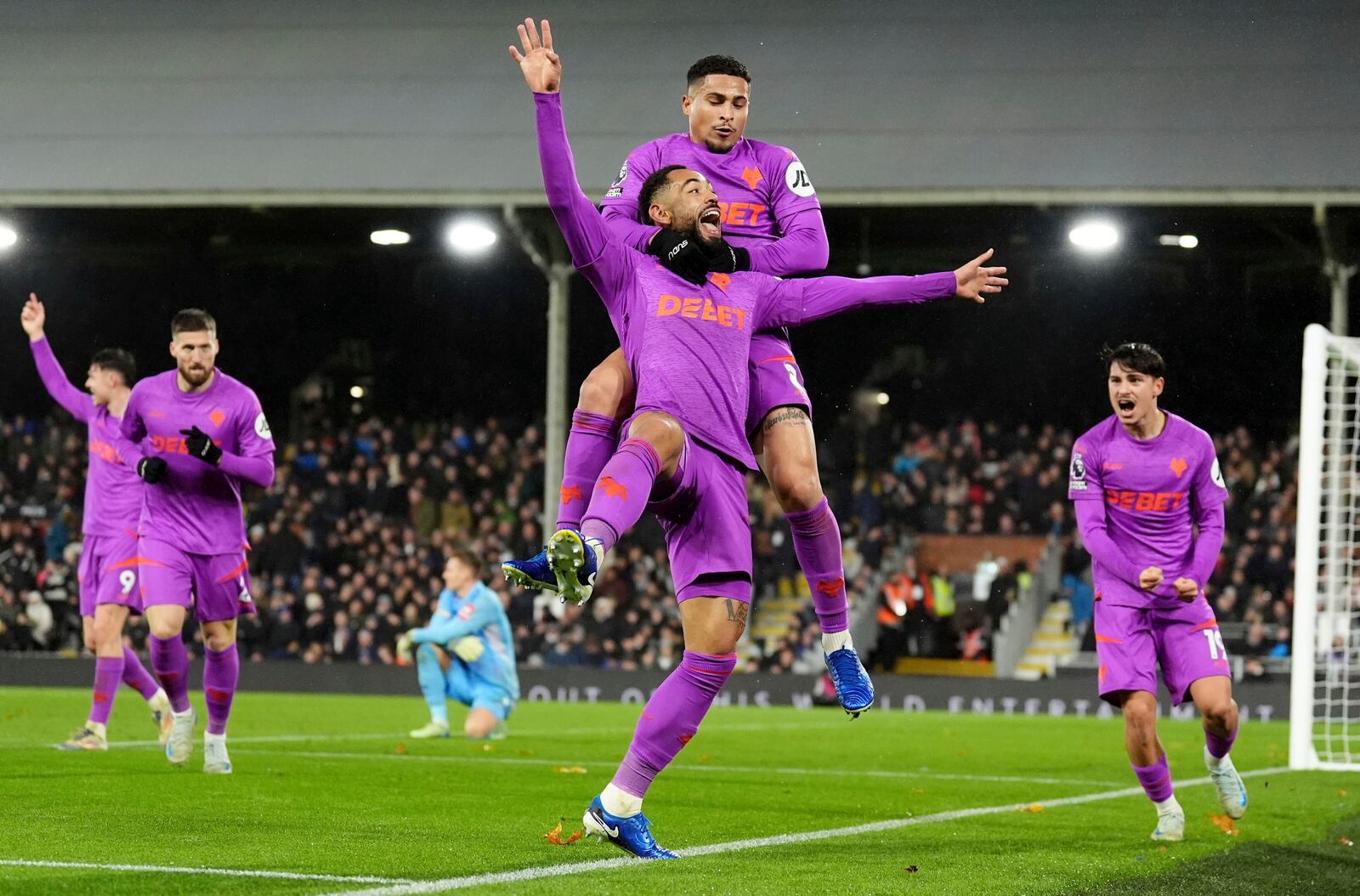 Wolverhampton Wanderers' Matheus Cunha, centre, celebrates after scoring his sides third goal during the English Premier League match between Fulham and Wolverhampton Wanderers at Craven Cottage stadium in London, Saturday, Nov. 23, 2024. (Zac Goodwin/PA via AP)