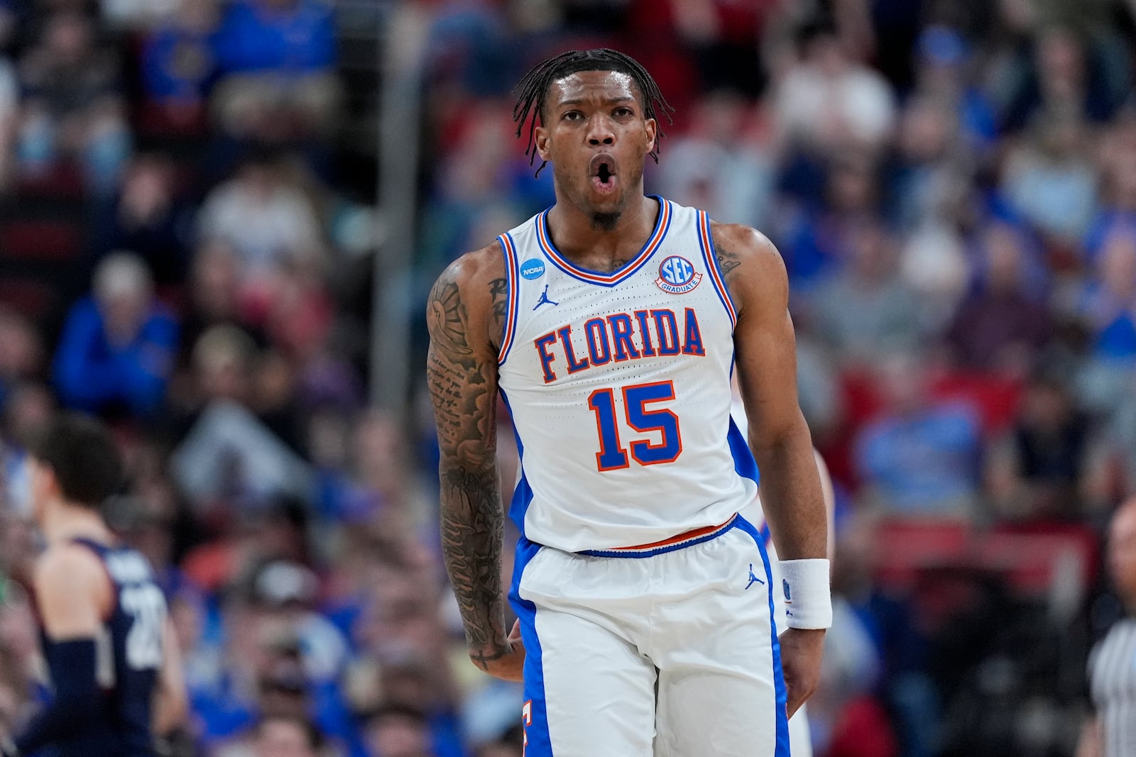 Florida guard Alijah Martin celebrates after scoring against UConn during the first half in the second round of the NCAA college basketball tournament, Sunday, March 23, 2025, in Raleigh, N.C. (AP Photo/Chris Carlson)