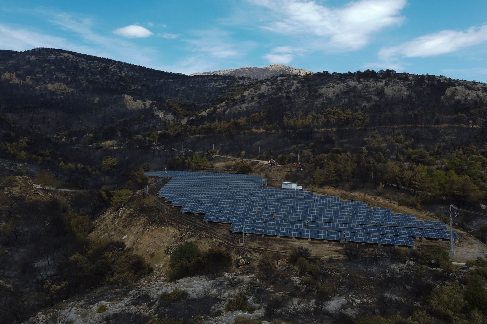 FILE - Solar panels operate near a burned forest in Acharnes suburb, on Mount Parnitha, in northwestern Athens, Greece, Aug. 27, 2023. (AP Photo/Michael Varaklas, File)