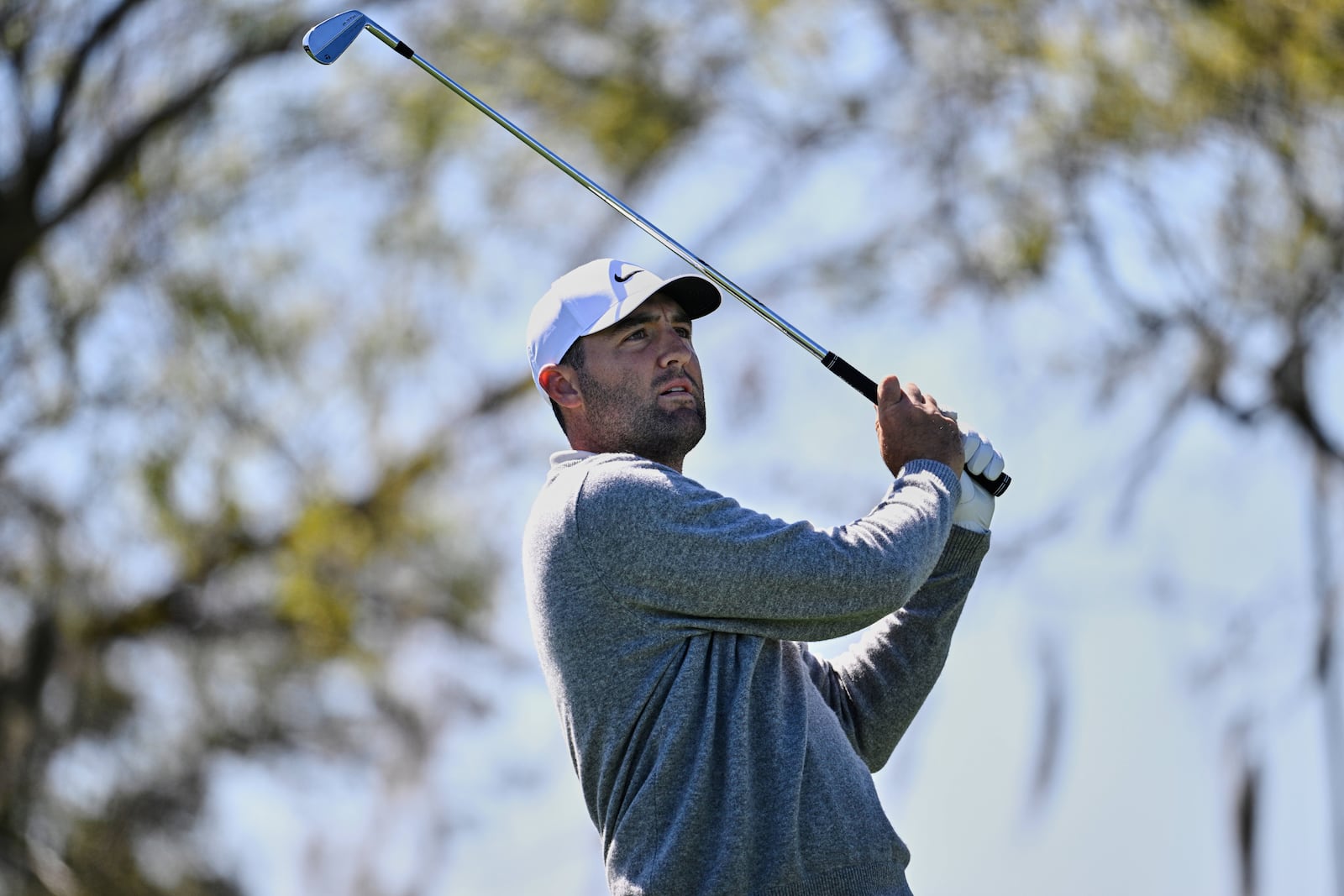 Scottie Scheffler watches his tee shot on the seventh hole during the first round of a Arnold Palmer Invitational at Bay Hill golf tournament, Thursday, March 6, 2025, in Orlando, Fla. (AP Photo/Phelan M. Ebenhack)