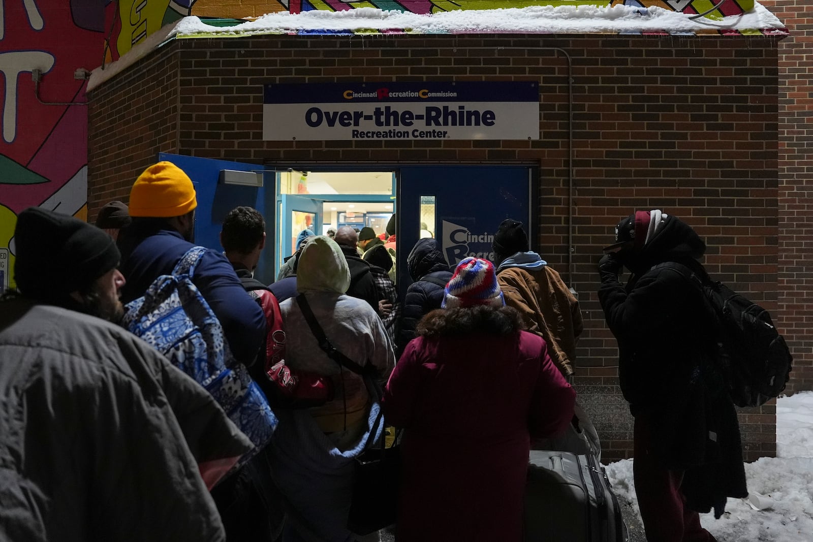 Patrons enter a daytime warming shelter as it opens for the day, Tuesday, Jan. 7, 2025, in Cincinnati. (AP Photo/Joshua A. Bickel)