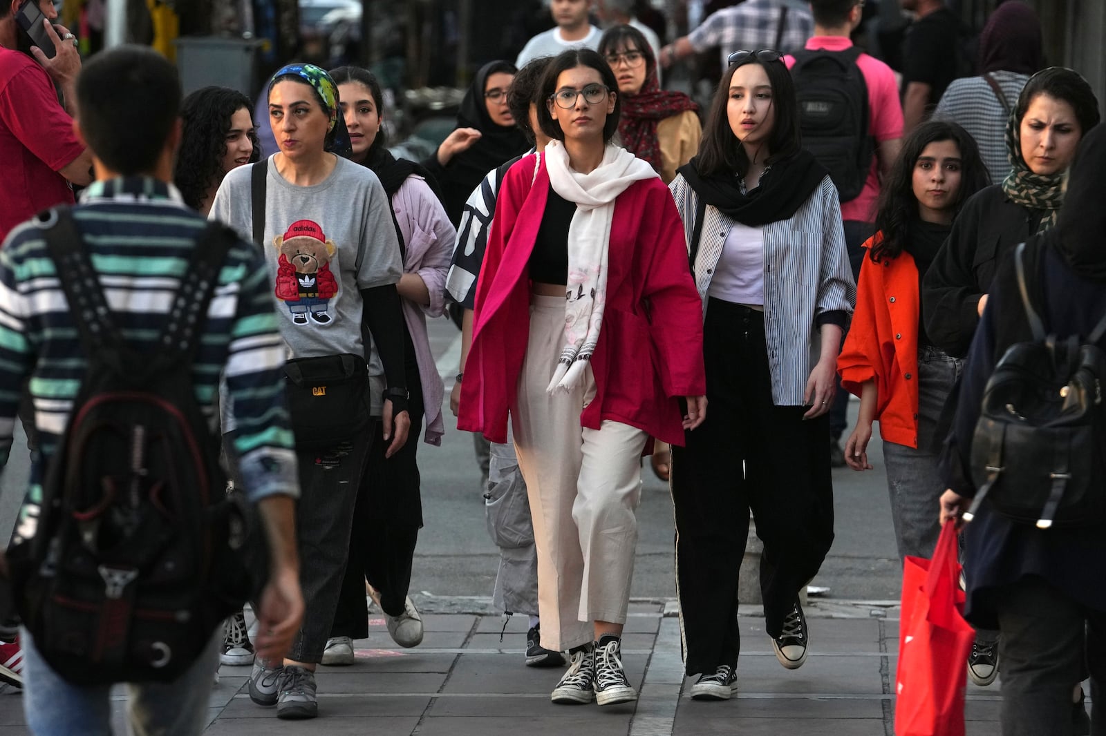 FILE Iranian women, some without wearing their mandatory Islamic headscarves, walk in downtown Tehran, Iran, Saturday, Sept. 9, 2023. (AP Photo/Vahid Salemi, File)