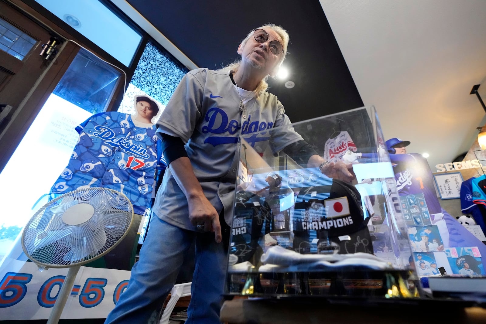 Hironobu Kanno, representative of a private fan club of Shohei Ohtani of the Los Angeles Dodgers, shows his collection items at his beauty salon in Oshu, northeastern Japan, the hometown of Ohtani, Tuesday, Oct. 29, 2024. (AP Photo/Eugene Hoshiko)