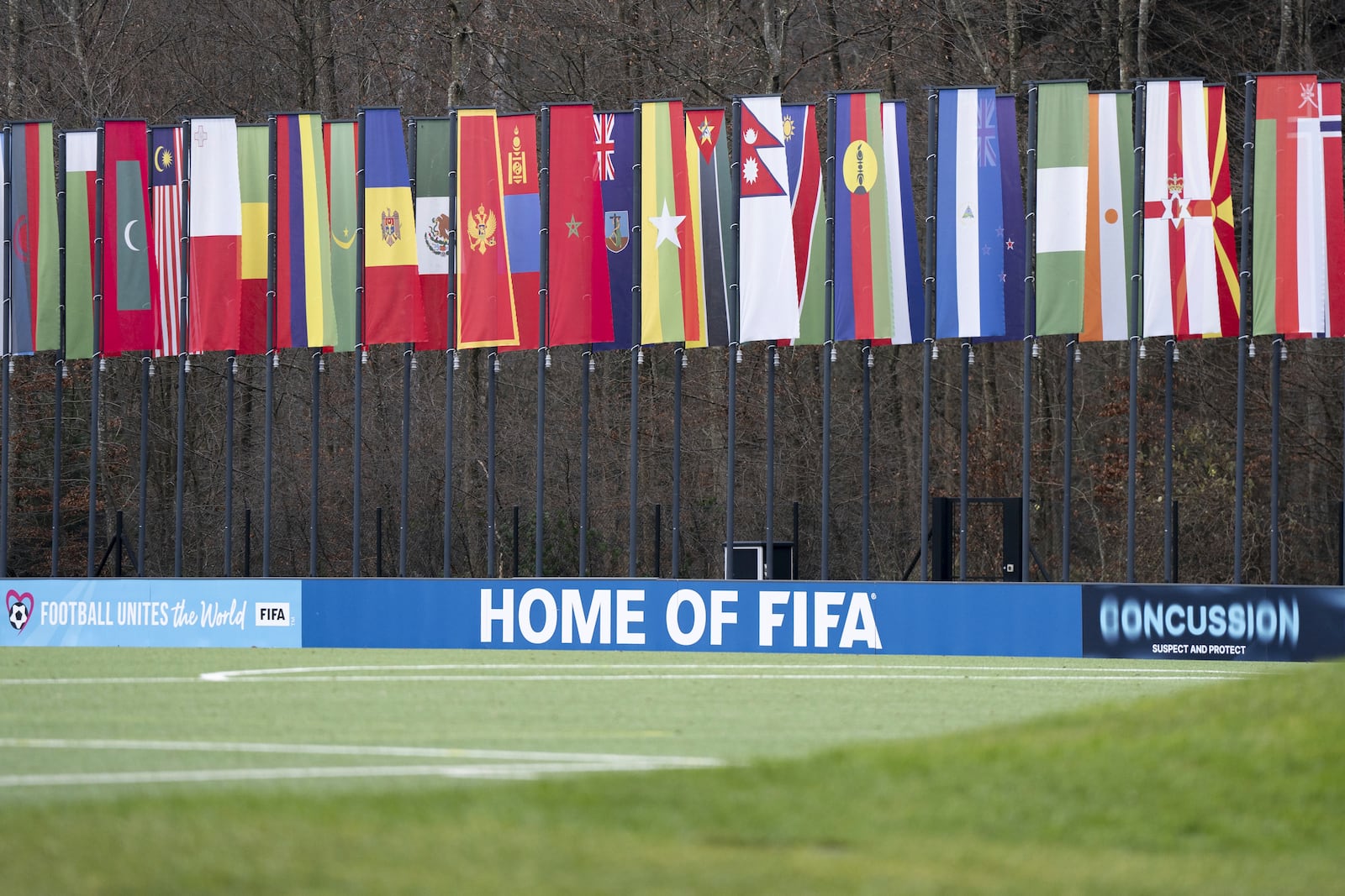 A soccer pitch with flags of the member states in the background is seen at the headquarters of the soccer association FIFA in Zurich, Switzerland, Wednesday, Dec. 11, 2024. (Til Buergy/Keystone via AP)