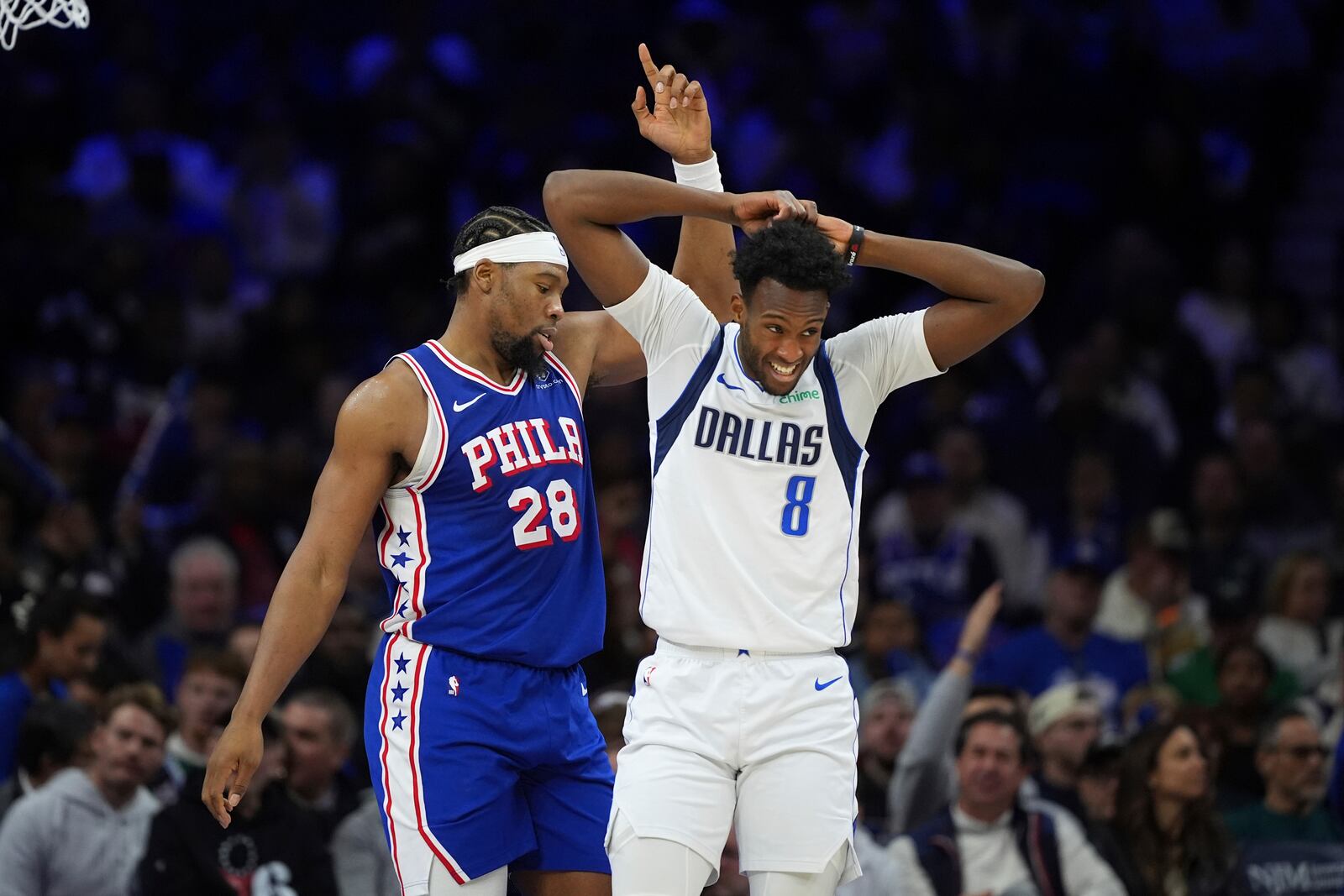 Philadelphia 76ers' Guerschon Yabusele, left, and Dallas Mavericks' Olivier-Maxence Prosper react during the second half of an NBA basketball game, Tuesday, Feb. 4, 2025, in Philadelphia. (AP Photo/Matt Slocum)