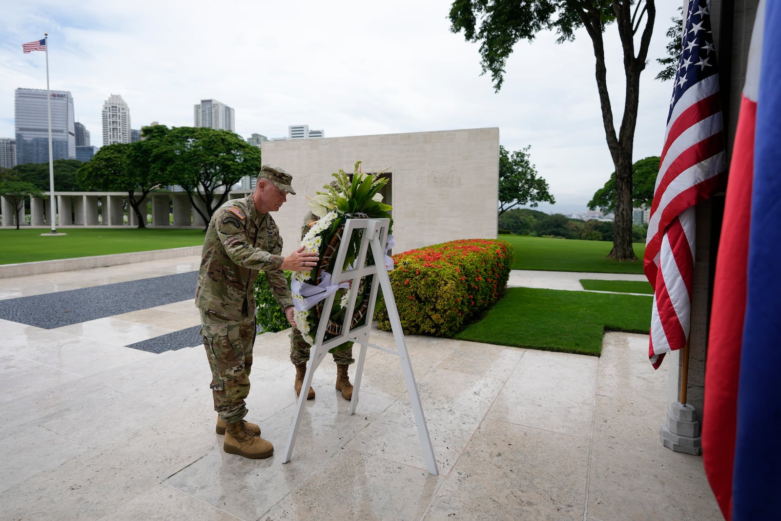 U.S. Maj. Gen. Marcus Evans, left, commanding general of the U.S. Army's 25th Infantry Division and Sgt. Major Shaun Curry arrange a wreath during rites to honor American soldiers died during World War II at the Manila American Cemetery and Memorial in Taguig, Philippines Monday, Oct. 21, 2024. (AP Photo/Aaron Favila)